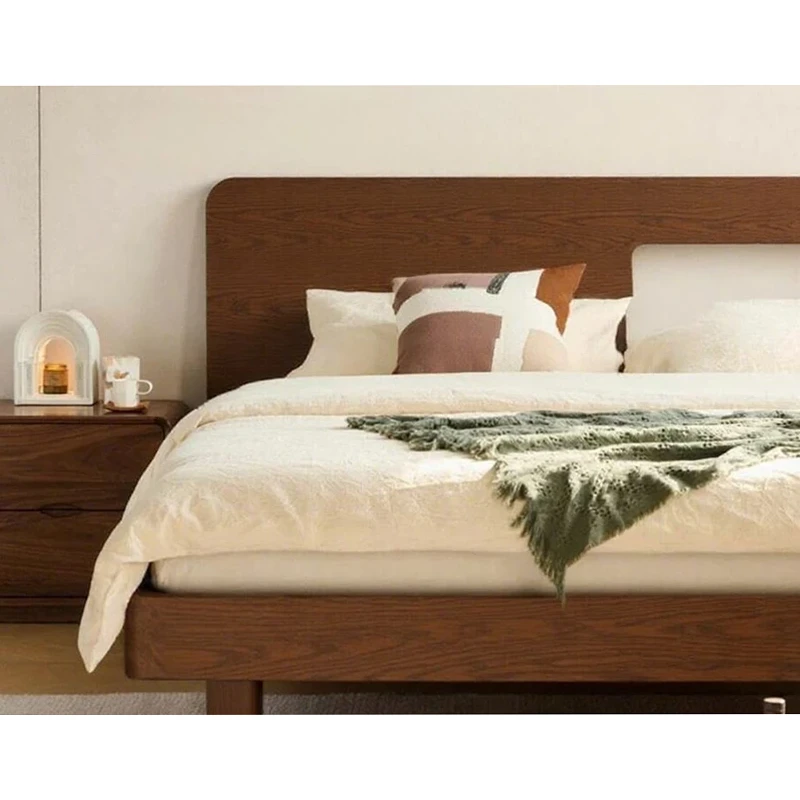 walnut-bed-double-sided-keel-ten-support-legs Walnut bed headboard close-up beside a matching nightstand with warm accent lighting