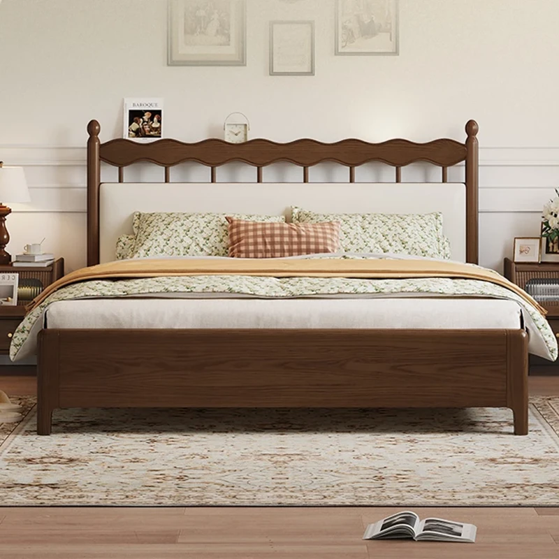 Walnut bed frame with cream headboard front view in a simple bedroom setting