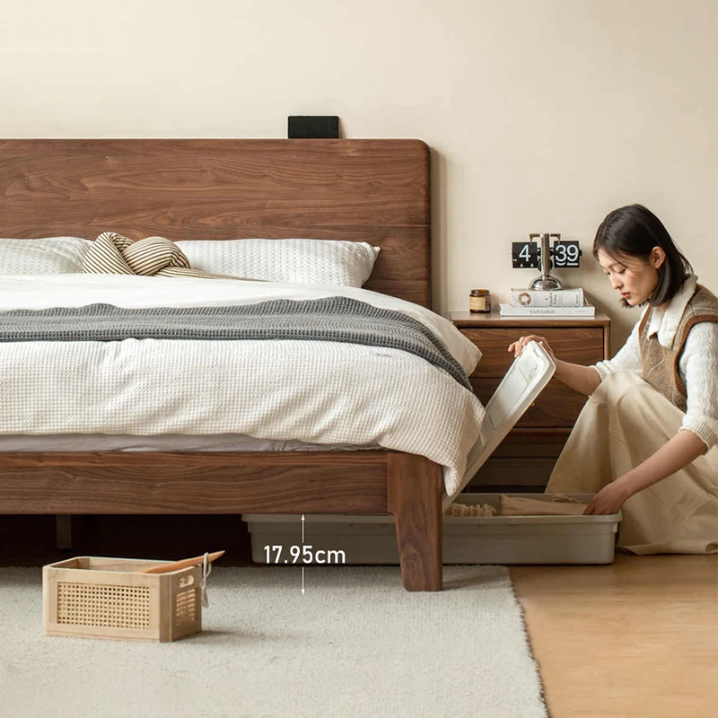 Walnut bed frame lifted open showing a spacious underbed storage area