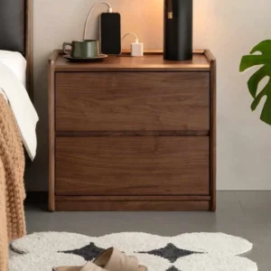 Walnut two drawer nightstand with charging top holding phone and lamps in a bedroom