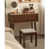 Wooden vanity stool tucked under dressing desk in room scene